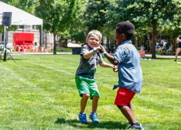 two children dancing outside