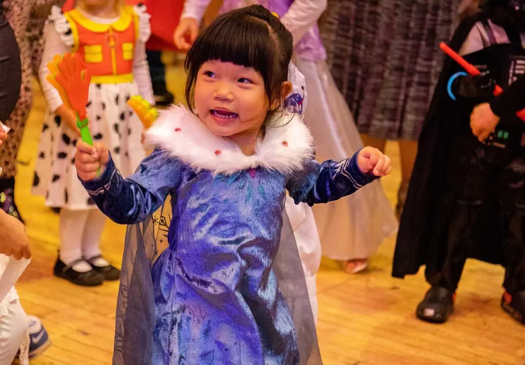 young girl in purple princess costume with wand