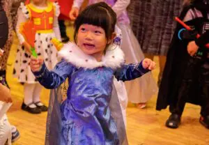 young girl in purple princess costume with wand