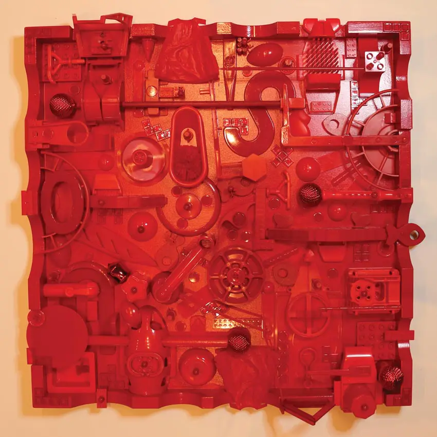 square red artwork featuring an assemblage of machinery pieces