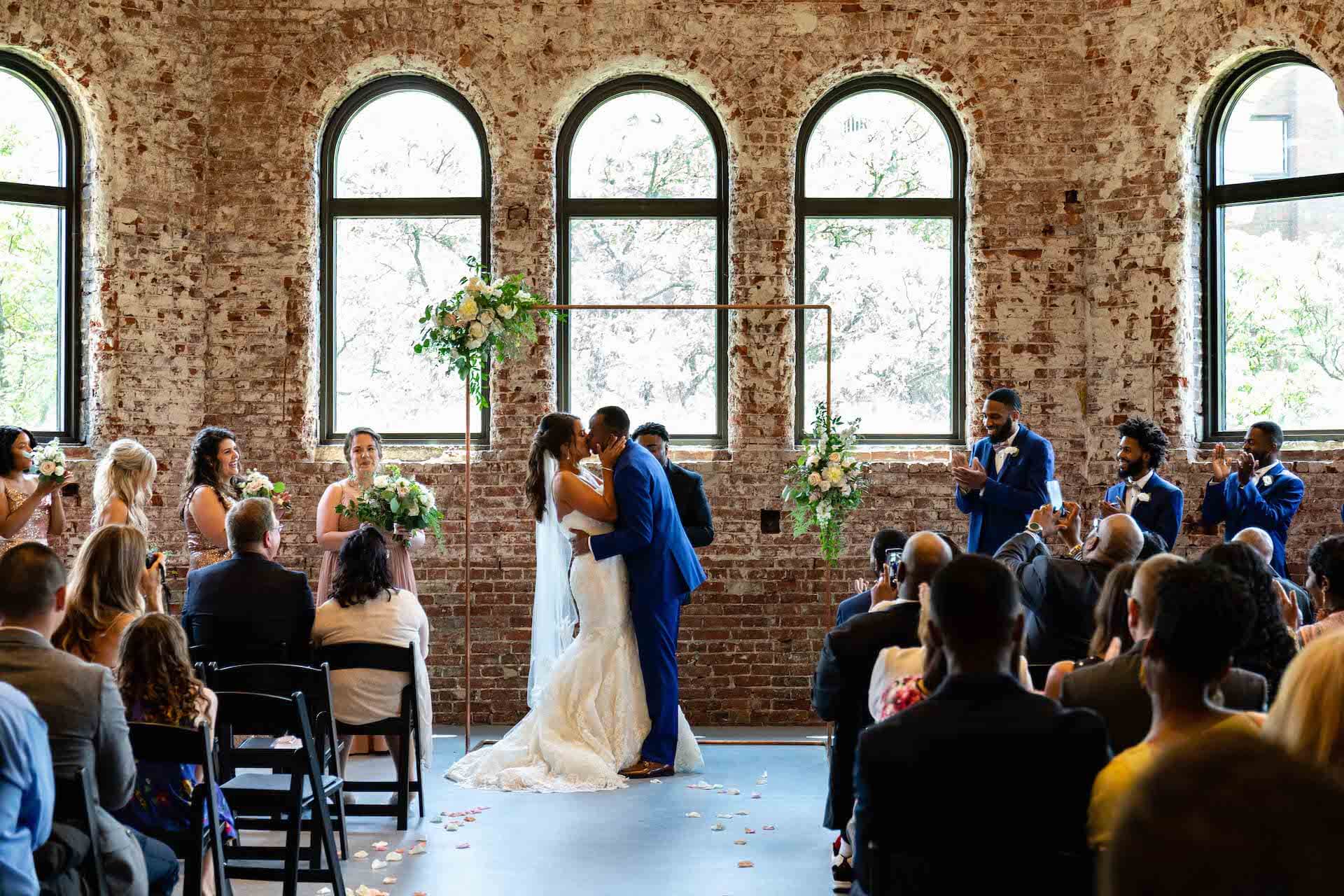 wedding couple kissing in assembly hall in museumlab