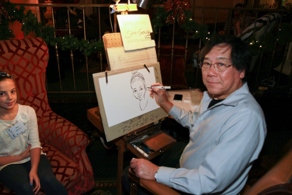 Sam Thong at an easel drawing a girl