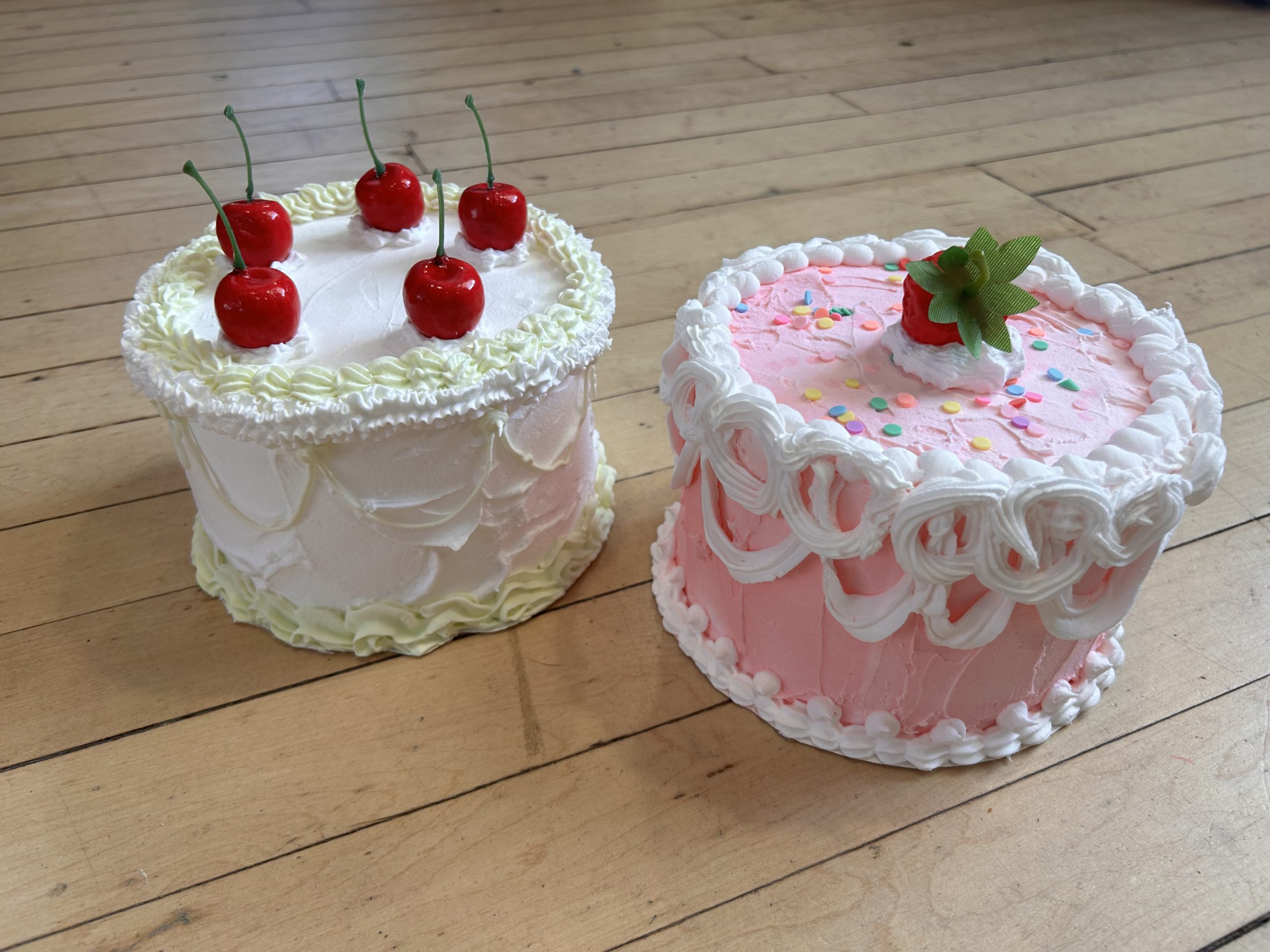 two fancy decorated cakes that are made out of inedible materials