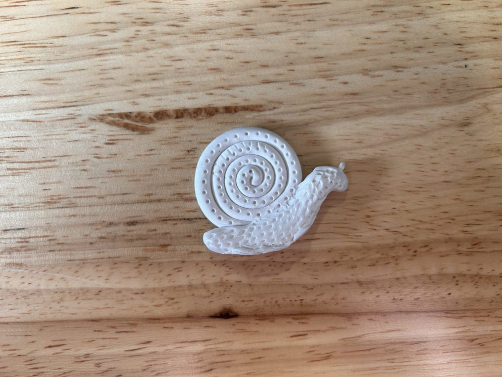A plaster-cast snail sits on a table