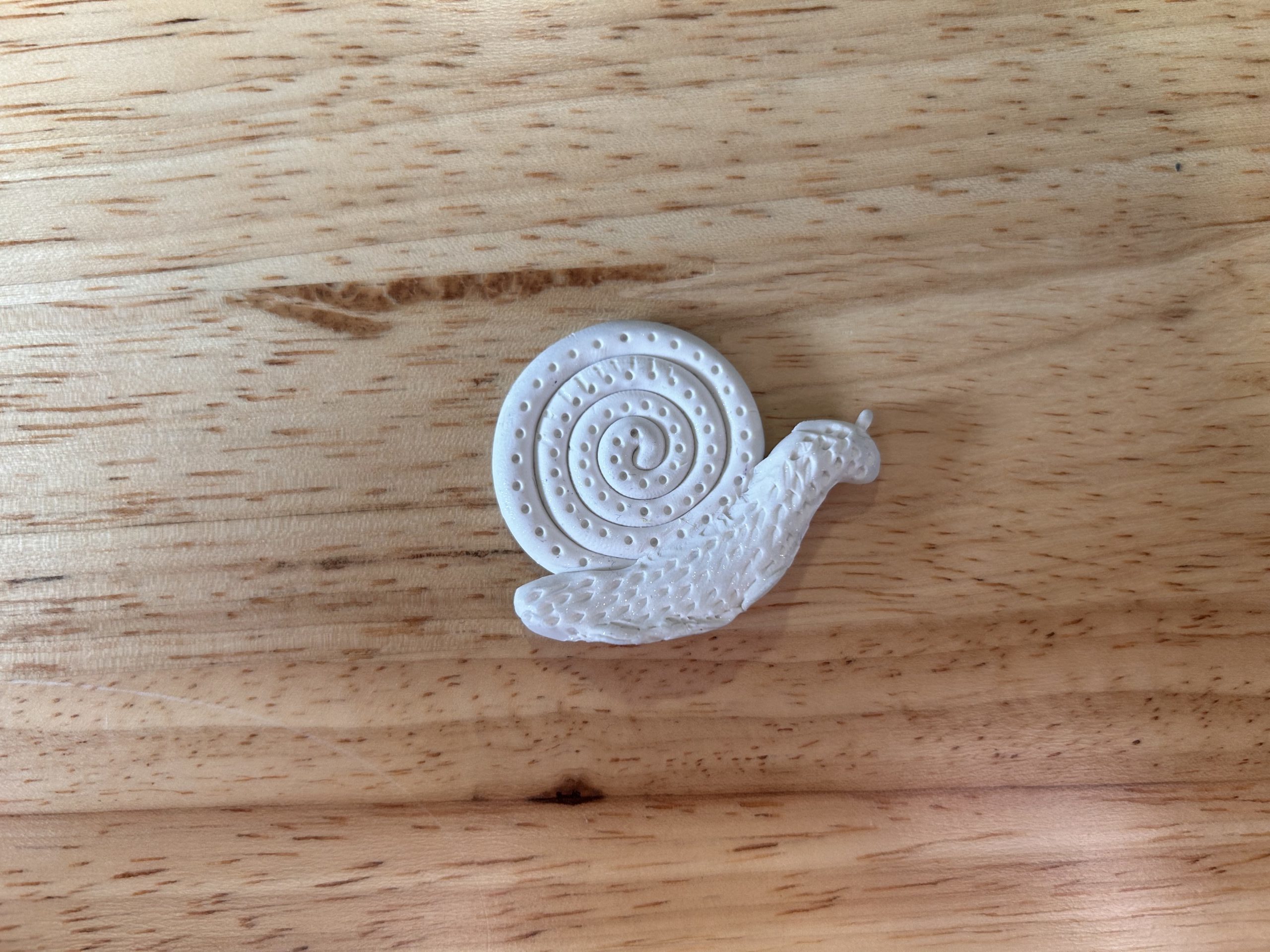 A plaster-cast snail sits on a table