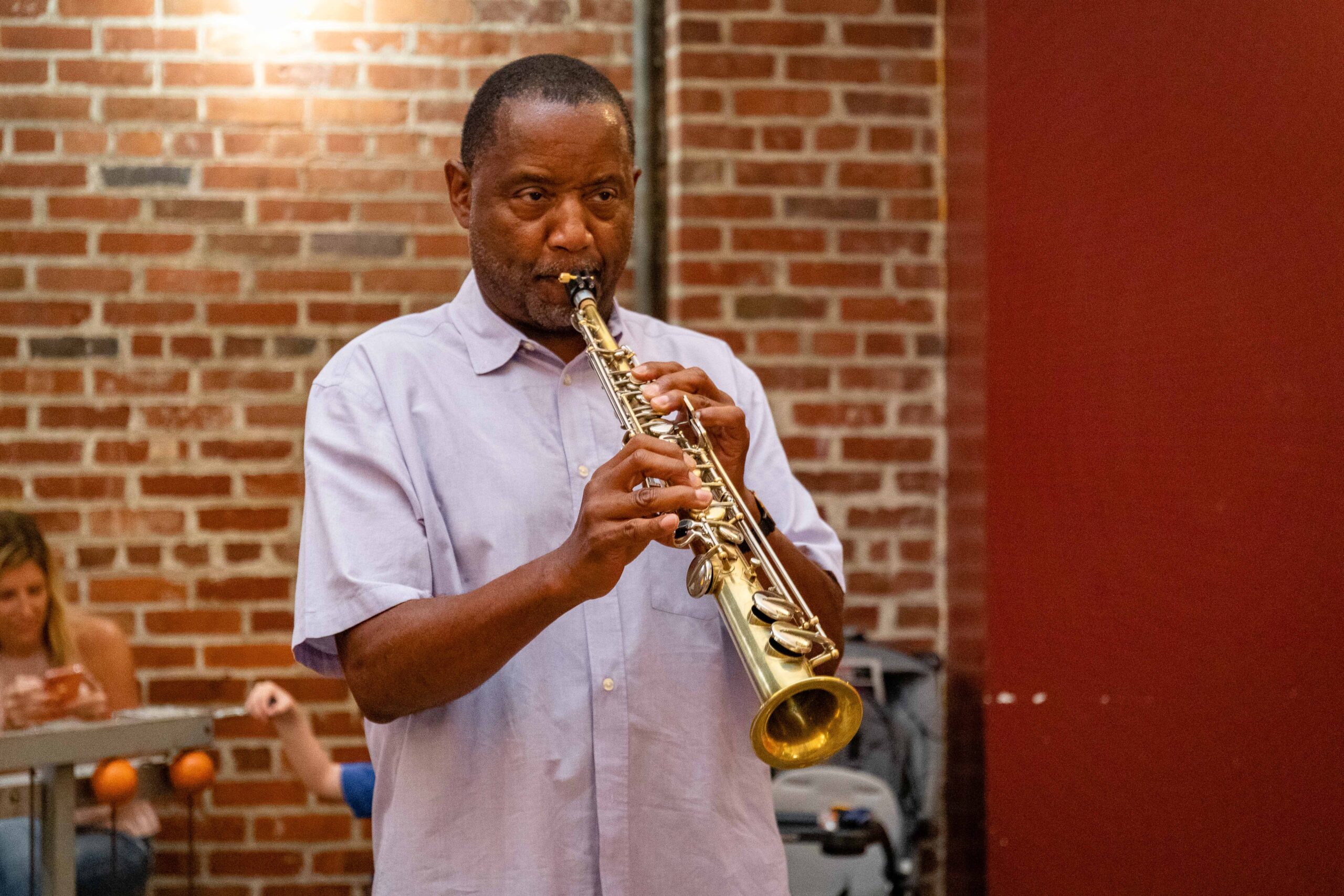 Lee Robinson, saxophonist, plays a soprano saxophone