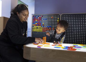 mother and young son at light table